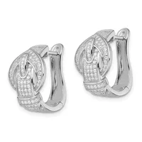 A pair of white metal huggie earrings with pave-set diamonds covering the surface in a curved, layered design, shown from front and back views.