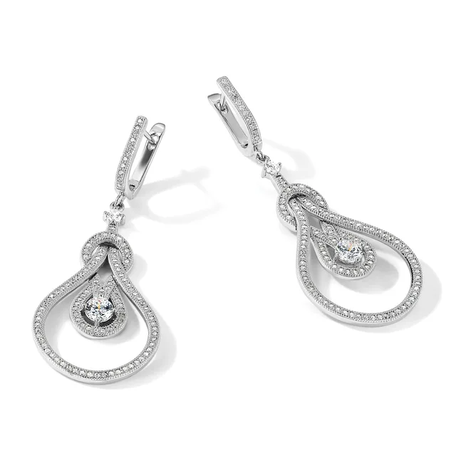 Pair of silver drop earrings with teardrop-shaped frames outlined in small diamonds, each suspending a round diamond from a hinged post closure.