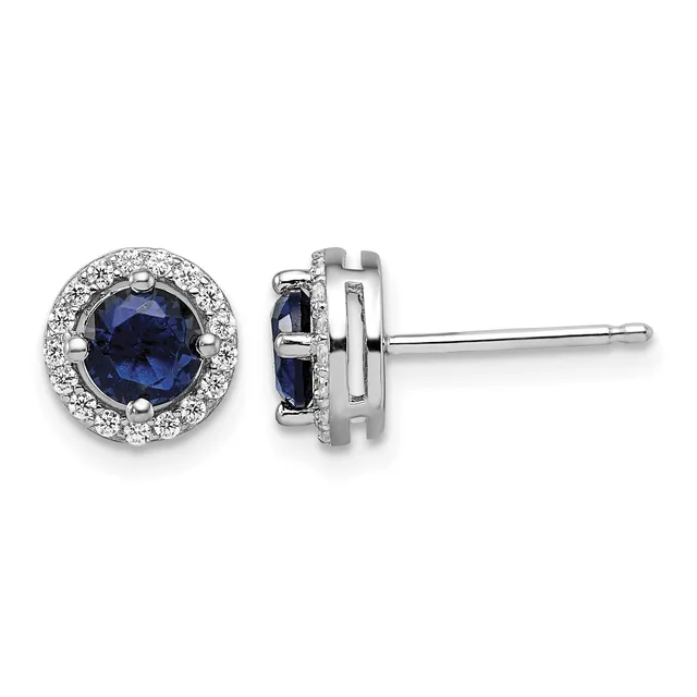 Pair of silver stud earrings with round dark blue sapphires surrounded by small diamonds, shown from front and side views.
