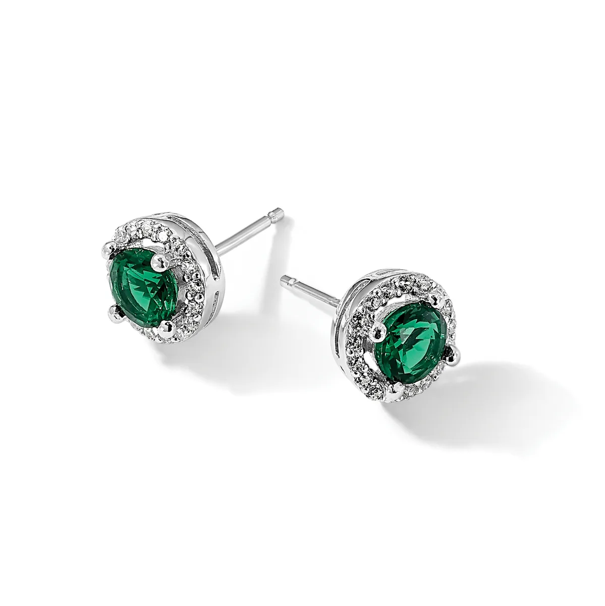 Pair of silver stud earrings with round emerald-green gemstones surrounded by diamond halos.