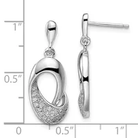 A pair of silver dangle earrings featuring polished oval tops with textured crescent-shaped bottoms, displayed against a measurement scale.
