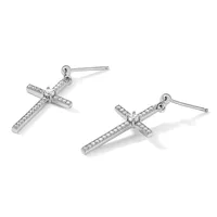 A pair of silver cross-shaped drop earrings with round diamond accents, shown from two angles against a white background.