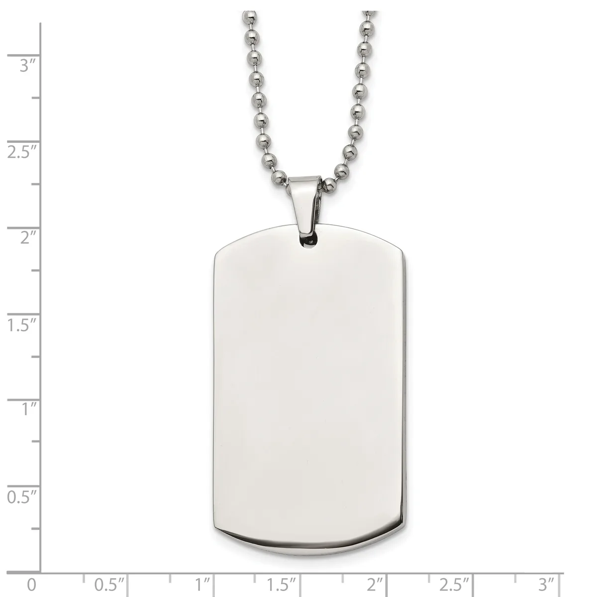 A blank polished stainless steel dog tag pendant with rounded corners hangs from a ball chain, shown against a measurement scale.