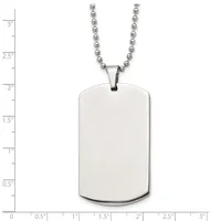 A blank polished stainless steel dog tag pendant with rounded corners hangs from a ball chain, shown against a measurement scale.