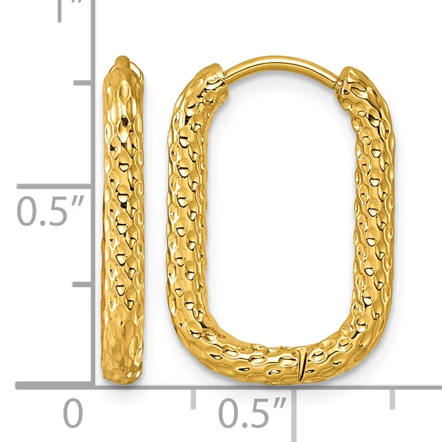 A pair of gold hoop earrings with a textured, dimpled surface finish displayed next to a measurement scale showing approximately one inch in length.