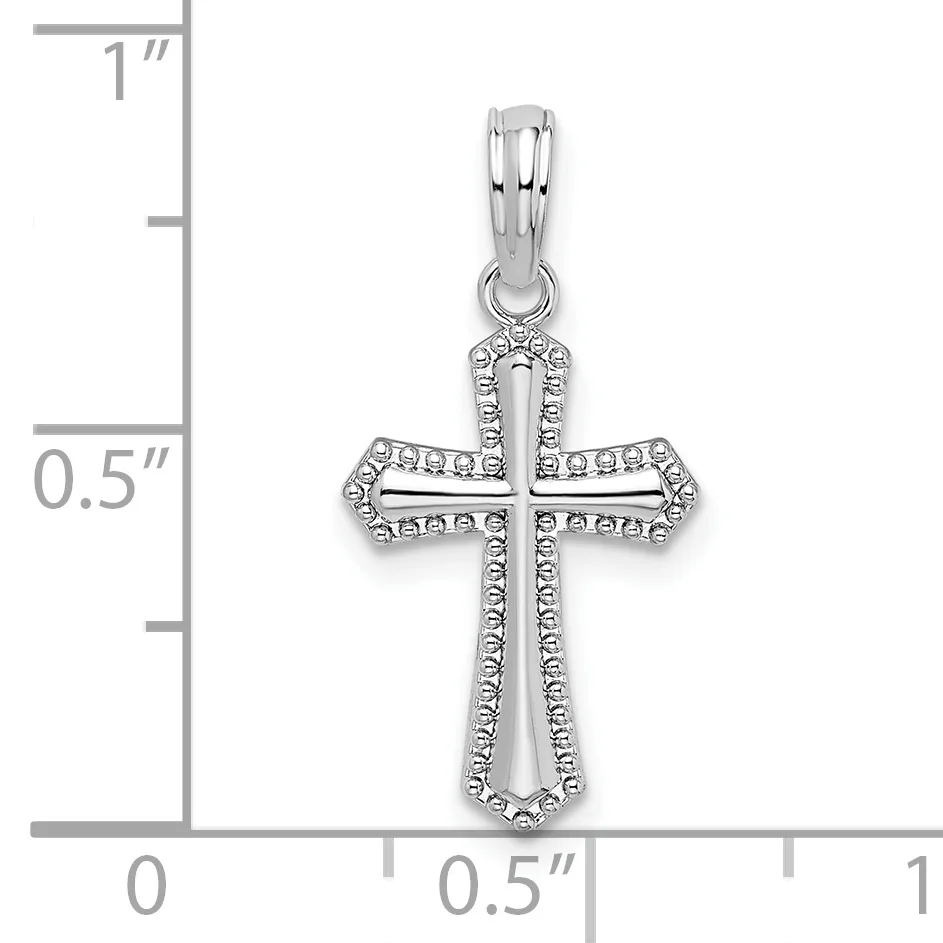 Silver cross pendant with cubic zirconia outline and decorative detailing, shown against a ruler measuring approximately one inch in height.