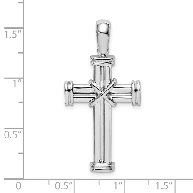 A polished silver cross pendant with vertical and horizontal bars adorned with a smaller decorative cross at the center, shown next to a measurement scale indicating approximately 1.5 inches in height.
