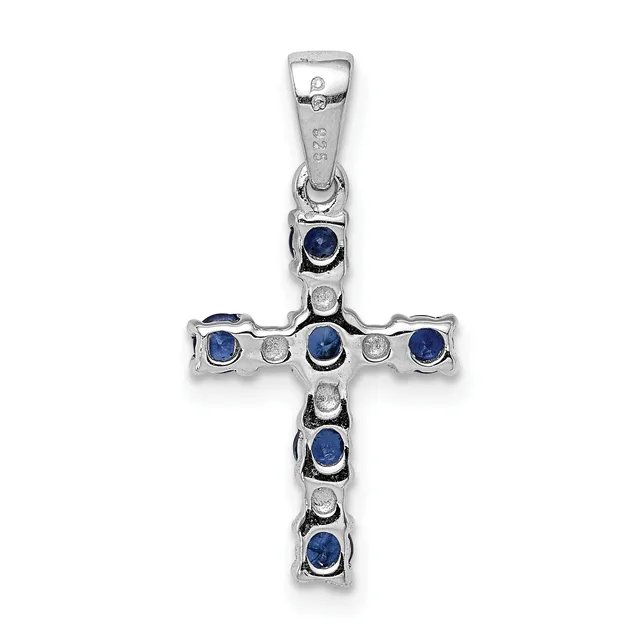 A sterling silver cross pendant featuring alternating round blue sapphires and small diamonds set in bezel settings along the vertical and horizontal arms, with a small hallmark visible on the bail.
