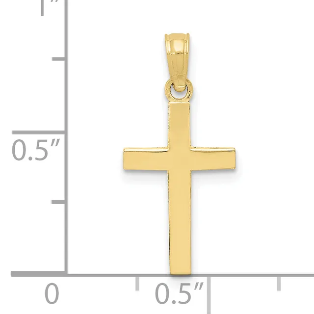 A polished gold cross pendant shown next to a ruler measuring approximately one inch in height.