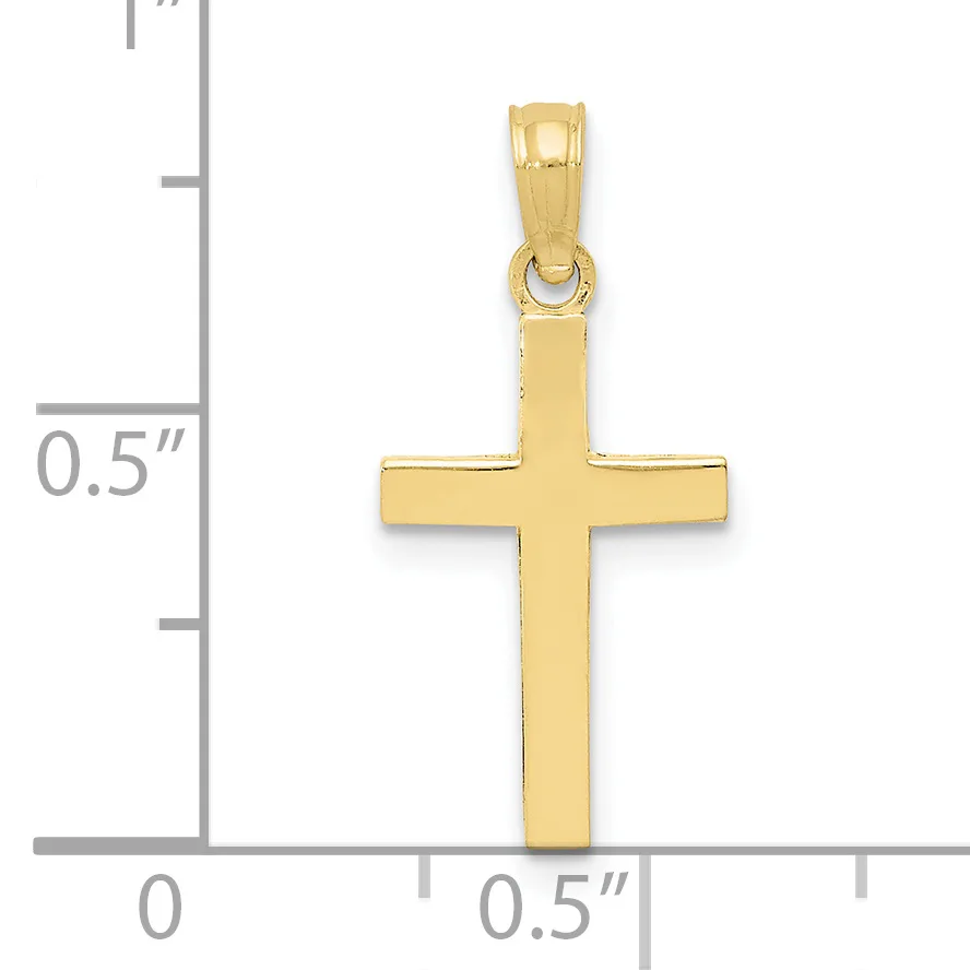 A polished gold cross pendant shown next to a ruler measuring approximately one inch in height.