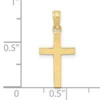A polished gold cross pendant shown next to a ruler measuring approximately one inch in height.