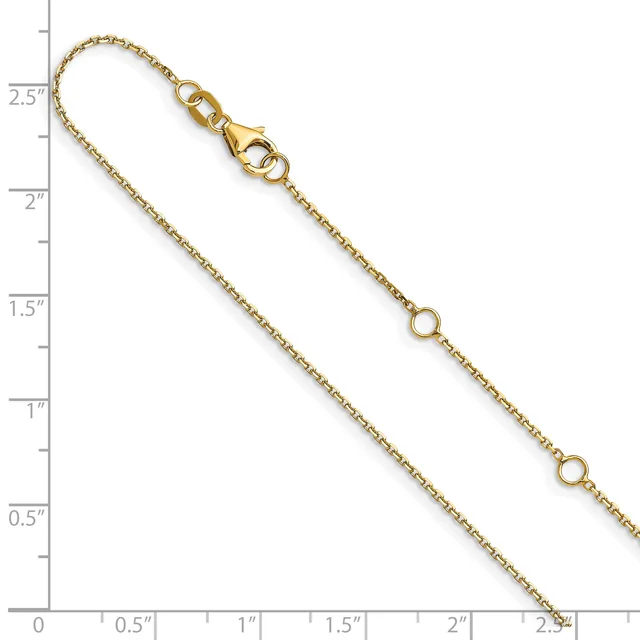 Gold-toned chain bracelet with lobster clasp and small ring charms, displayed against a ruler showing approximately 7 inches in length.