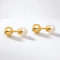 A pair of gold cufflinks with polished gold spheres connected to cream-colored pearl spheres, displayed on a white surface.