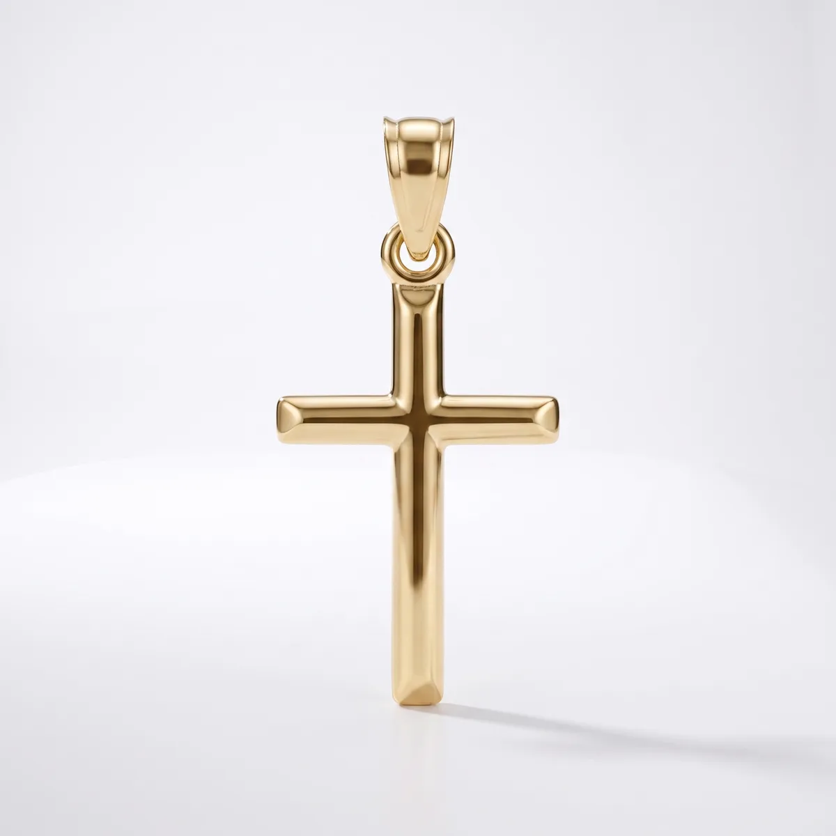 A polished gold cross pendant with a rounded bail loop at the top, shown against a white background.
