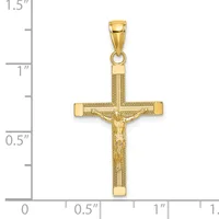 Gold crucifix pendant with textured surface and figure of Jesus Christ, shown next to a ruler measuring approximately 1.25 inches tall.