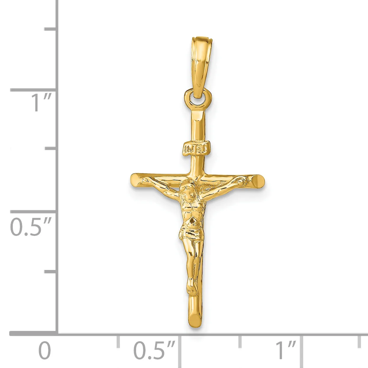 A polished gold crucifix pendant with a figure of Christ depicted on the cross, shown against a ruler indicating approximately one inch in height.