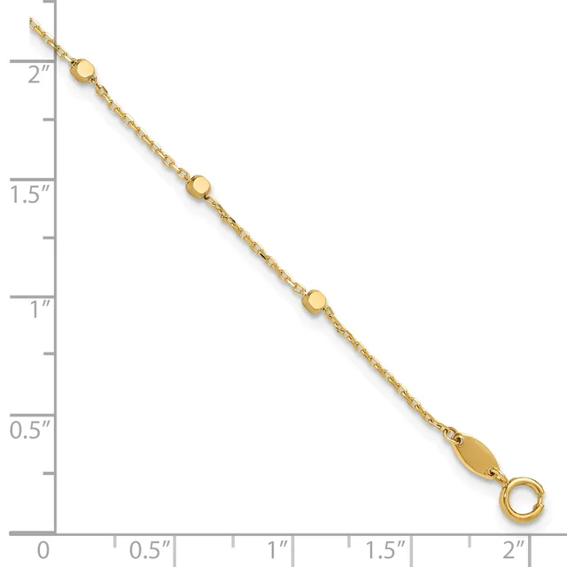 Gold-toned chain bracelet with three small round beads spaced along its length, displayed against a measurement ruler.