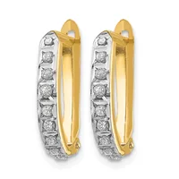 Pair of yellow and white gold hoop earrings with diamond accents along the outer edge and hinged backs.