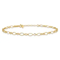 A gold-colored chain bracelet with alternating oval and circular links, featuring a clasp and extender chain on one end.