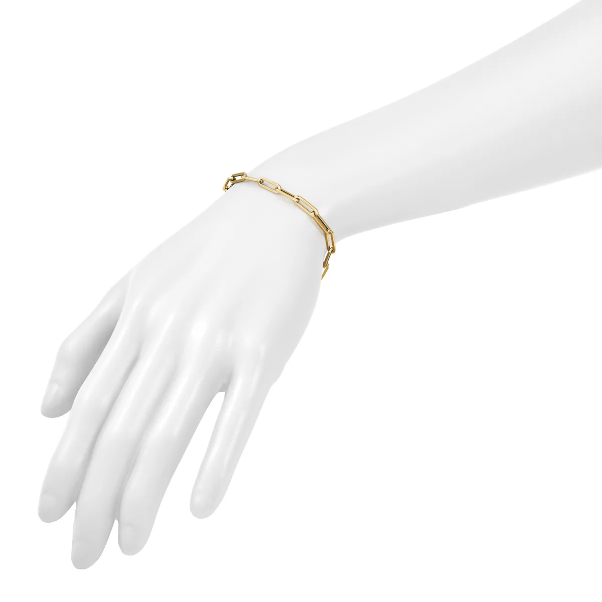 A gold-toned bamboo-style link bracelet worn on a white mannequin hand against a white background.