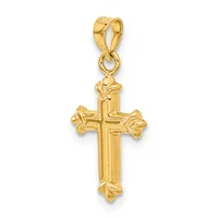 A gold cross pendant with ornate floral details at each end, suspended from a gold bail loop.