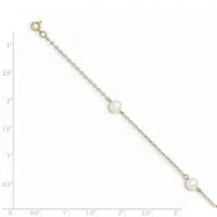 A gold chain bracelet with two pearl stations displayed against a measurement scale.