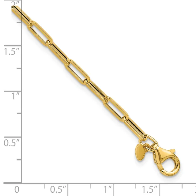 Gold-toned paperclip chain bracelet with a lobster clasp and small charm, displayed against a ruler showing approximately 2 inches in length.