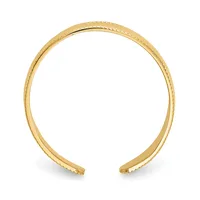 A gold-toned open cuff bracelet with a textured beaded edge detail, shown against a white background.