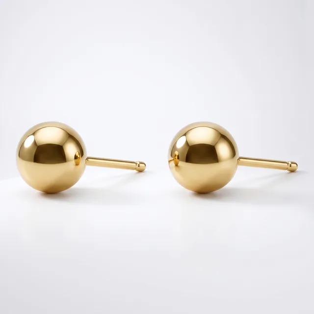 A pair of polished gold sphere stud earrings with posts and backs, displayed on a white background.