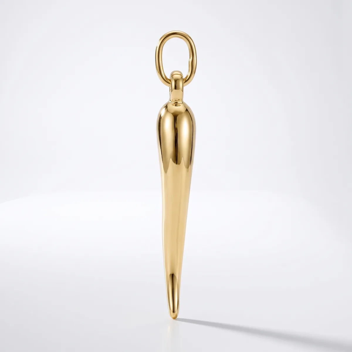 A polished brass pendant with an elongated tapered body and oval loop at the top, displayed against a white background.