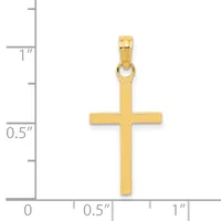 A polished gold cross pendant shown next to a ruler indicating its size is approximately one inch tall and half an inch wide.