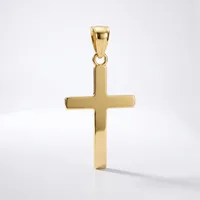 A polished gold cross pendant with a rectangular shape and small bail loop at the top, displayed against a white background.