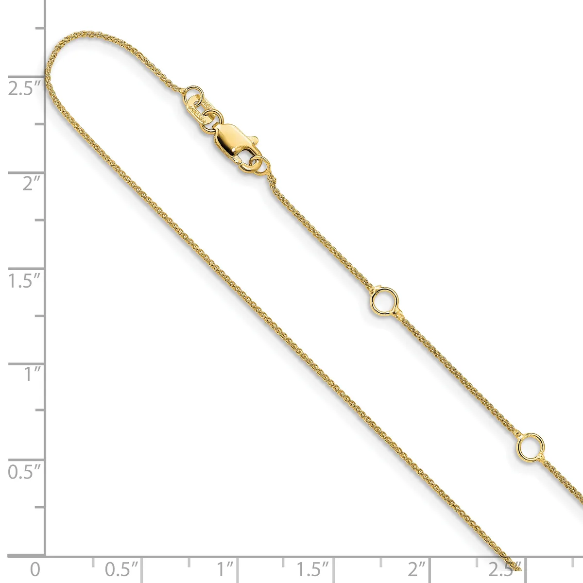 Gold-toned chain bracelet with a lobster clasp and small circular links, displayed against a ruler showing it measures approximately 2.5 inches in length.