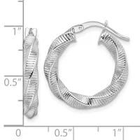 Pair of silver twisted hoop earrings with textured surface and post backs, shown next to a ruler measuring approximately one inch in diameter.