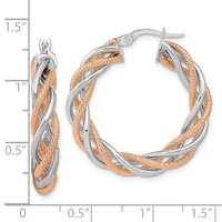 Two-tone twisted hoop earrings with rose gold textured outer strands and silver smooth inner strands, approximately 1.25 inches in diameter, shown with measurement scale.