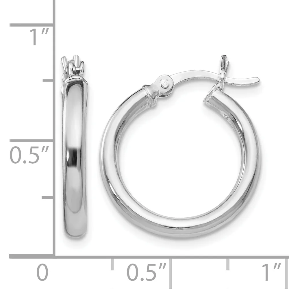 Polished silver-toned hoop earrings with a thick tubular design and hinged closures, displayed next to a measurement scale showing approximately one inch in length.