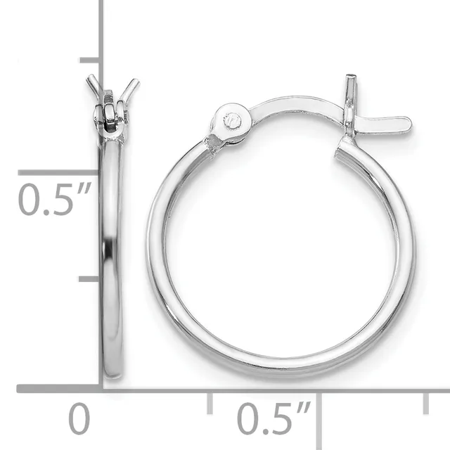 A pair of silver hoop earrings with a polished finish and hinged clasp closures, displayed against a measurement scale showing approximately 0.5 inches in diameter.
