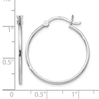A pair of silver hoop earrings with a polished finish and hinged closures, displayed next to a measurement ruler showing approximately one inch in diameter.
