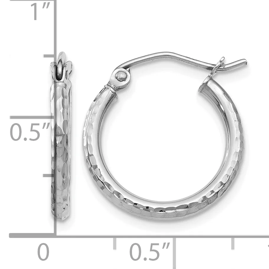 A pair of silver hoop earrings with a textured hammered finish and hinged post closures, shown with measurement scale indicating approximately one inch in length.
