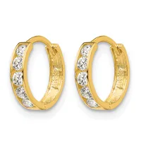 Pair of oval gold hoop earrings with five channel-set round white cubic zirconia stones along the front, featuring a hinged closure.