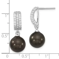 A pair of silver drop earrings with diamond-paved rectangular tops and dark pearl spheres suspended below, shown next to a measurement ruler.