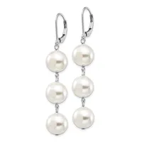 A pair of silver lever-back earrings featuring three graduated white pearls connected by small chain links on each earring.