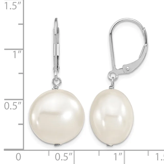 A pair of white pearl drop earrings with silver lever-back closures displayed next to a ruler showing approximately 1.25 inches in length.
