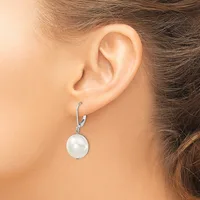 A woman wearing a silver lever-back earring with a white pearl pendant hanging from it, shown from the side profile of her ear and neck.