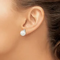A woman wearing a pearl stud earring with a small diamond or crystal accent, shown from the side view near her ear.