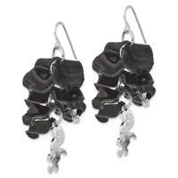 Pair of black resin roller skate charm earrings with silver-toned metal wheels and hooks, suspended from silver ear wires.
