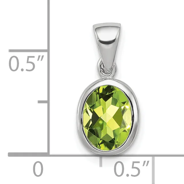 Silver pendant with oval faceted yellow-green peridot stone set in bezel, shown with size scale indicating approximately 0.5 inches in height and width.