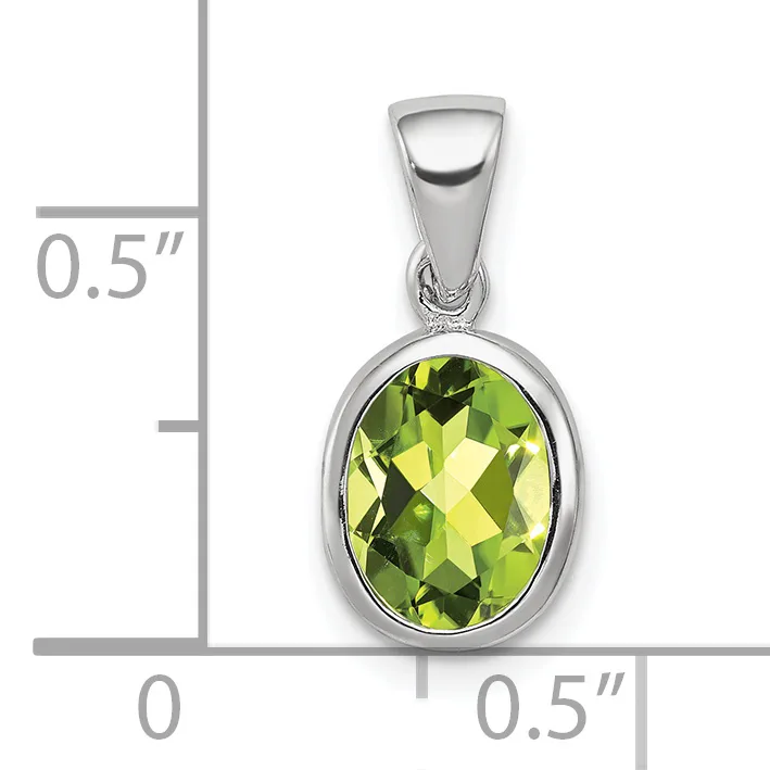 Silver pendant with oval faceted yellow-green peridot stone set in bezel, shown with size scale indicating approximately 0.5 inches in height and width.