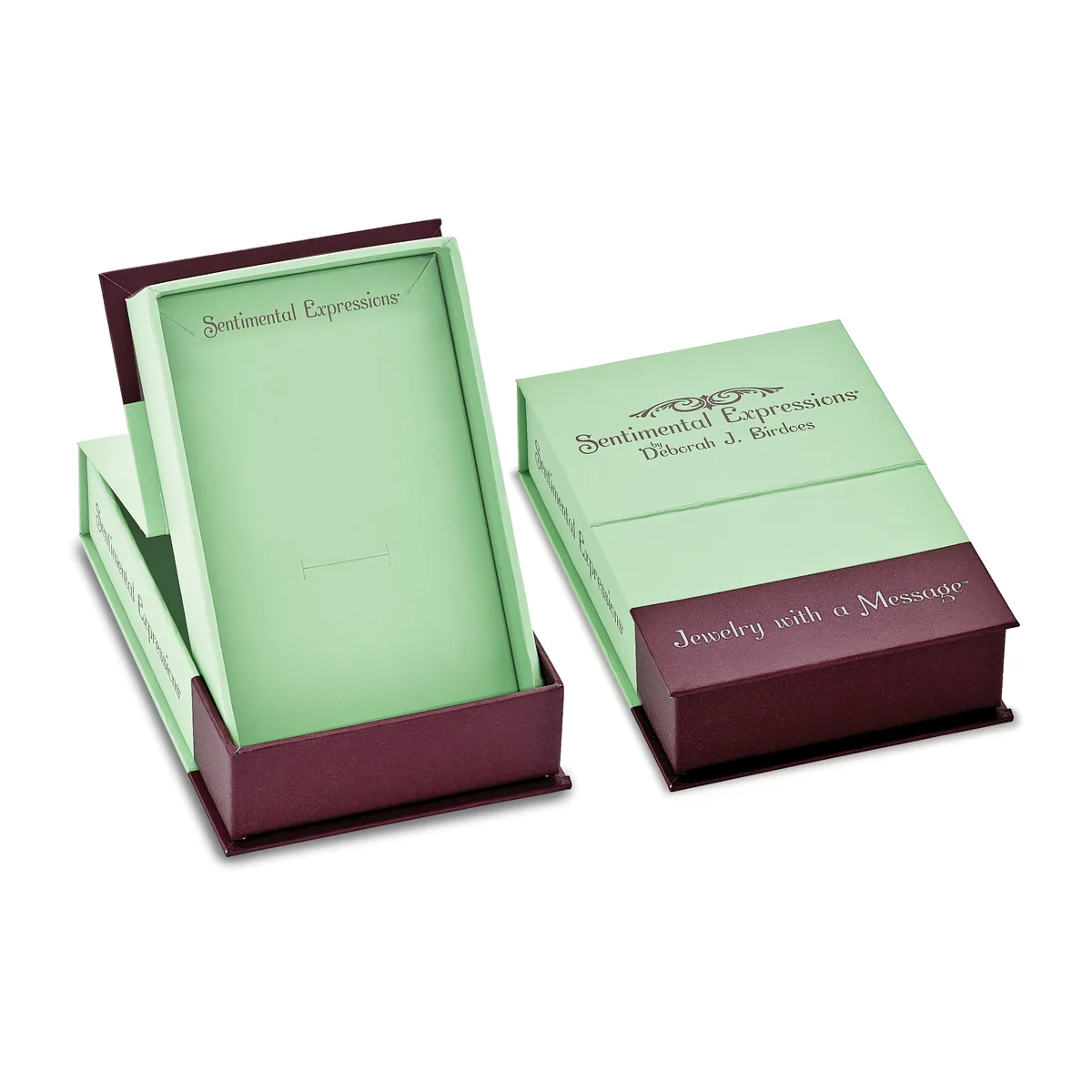 Two open boxes with burgundy exteriors and pale green interiors containing layered green papers and burgundy-trimmed cards.
