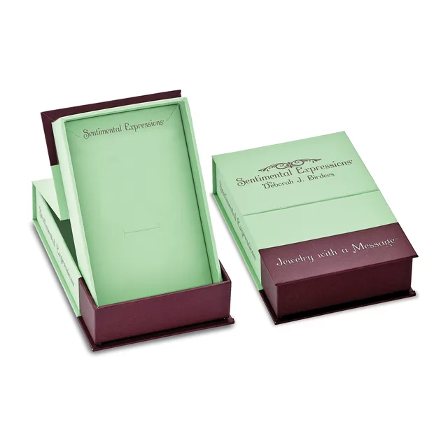 Two burgundy boxes with light green interior packaging and cream-colored cards labeled "Sentimental Expressions," displayed open and closed.